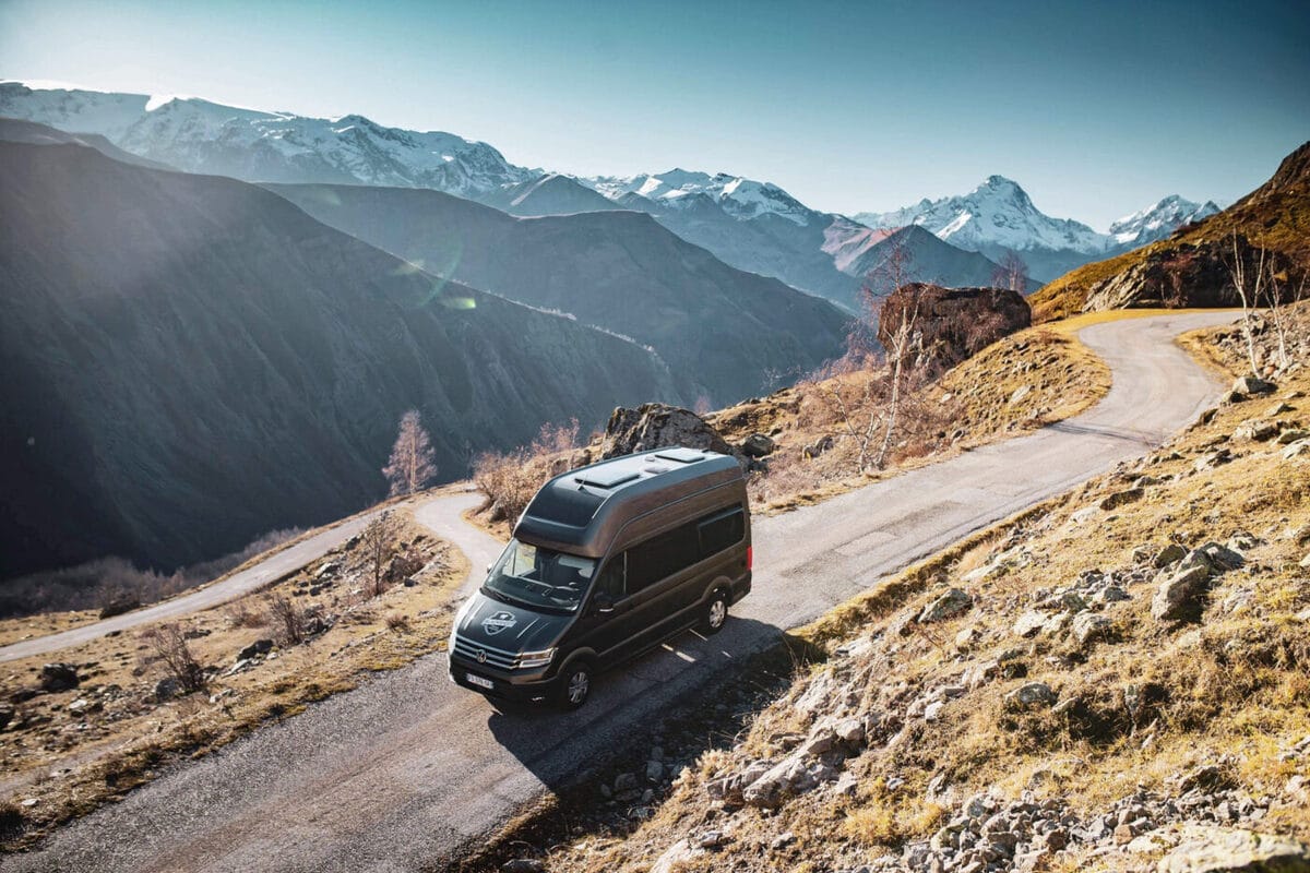 Un fourgon Blacksheep sur une route de montagne en automne